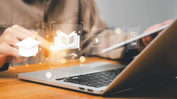 istock E-library concept. Person use laptop with virtual E-book icons for electronic books online, knowledge base on internet, digital library or e-library. Internet e-learning lessons and online 2171443041
