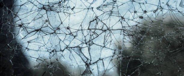 istock Pattern on cracked window glass. damage to glass. cracked texture. broken window 2171445523