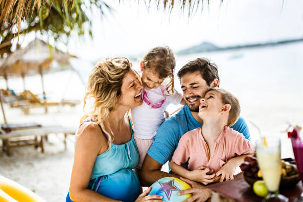 istock Happy parents having fun with their small kids on the beach. 2171448211