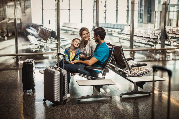 istock Happy family talking while waiting their transportation on a station. 2171448491