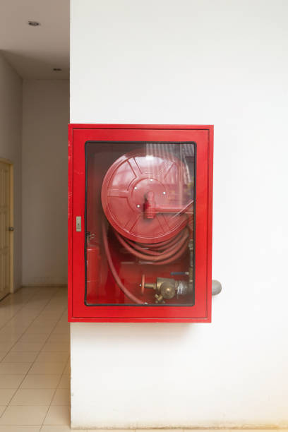 istock A red fire hydrant in a clear glass case is mounted on a white wall 2171448829