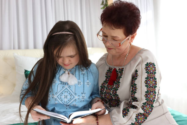 istock A girl with Down syndrome flips through a book with her mother. 2171449498