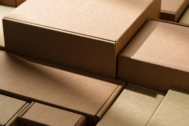 istock Stacked cardboard boxes arranged in a neat pattern under natural light 2171450354