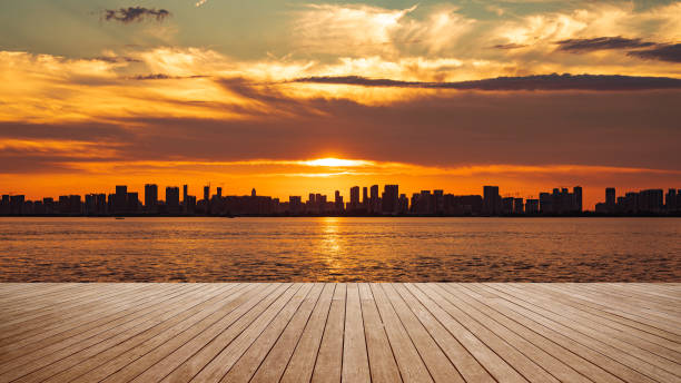 istock Empty boardwalk and modern urban skyline with dramatic sky and clouds during sunset 2171450964
