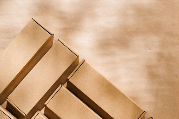 istock Brown cardboard boxes arranged on a neutral background in a warehouse setting during daylight hours 2171452493