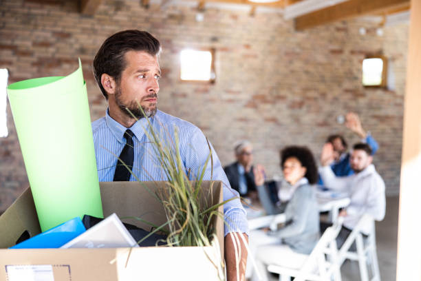 istock Depressed businessman leaving the office after being fired. 2171455627