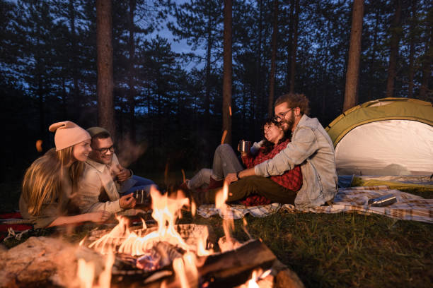 istock Young happy couples enjoying on camping during evening in the woods. 2171456350