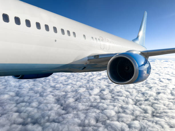 istock Passengers commercial airplane flying above clouds in sun light. Flying above clouds in dramatic sun light. Airplane in the sky. Detail of commercial jet airplane flying above clouds 2171456862