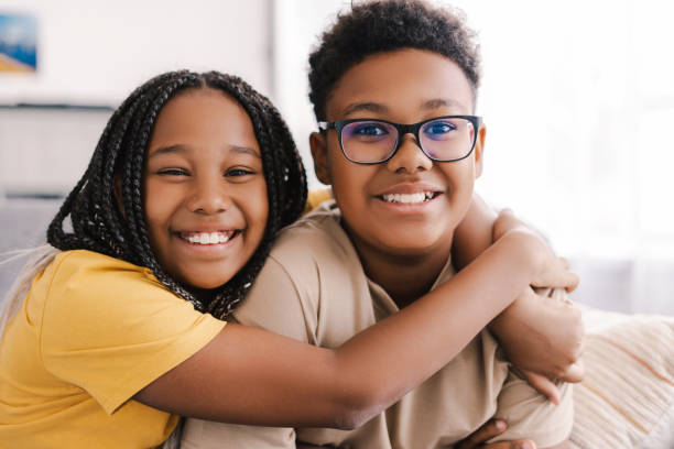 istock Two happy children hugging and smiling at home 2171457086