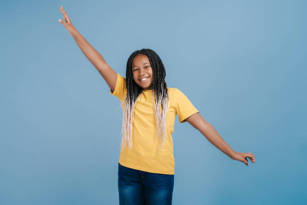 istock Positive smiling African girl with stylish dreadlocks having fun 2171457848