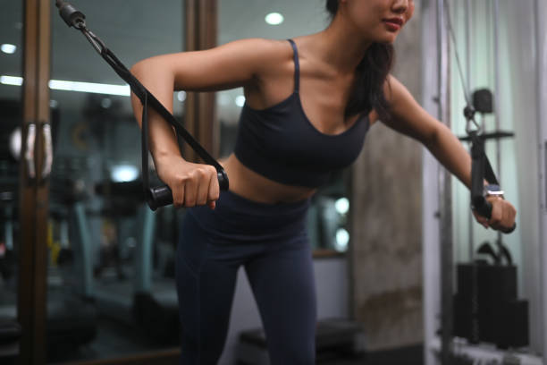 istock Strong athletic young woman doing triceps and shoulders workout training with cable machine at gym 2171458133