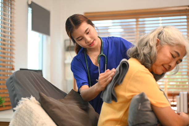 istock Physical therapist doing back percussion on a senior patient to help loosen and drain secretions from her lungs 2171458214