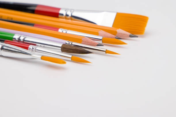 Pencils and brushes for drawing of different sizes. Close up view.