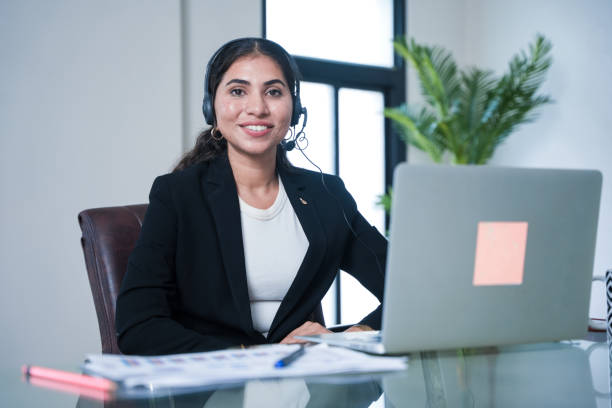 istock Happy indian service support operator or agent woman wearing headset looking at camera while working in office using laptop. call center and business communication concept. 2171460969