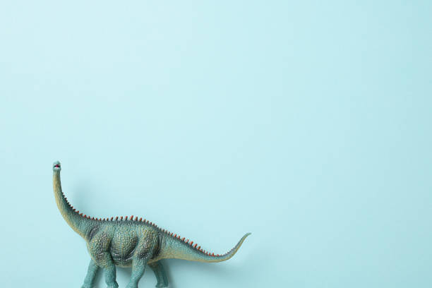 Brachiosaurus dinosaur toy isolated on blue background.