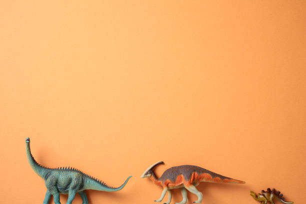 istock Different types of dinosaurs in a row on orange background 2171466993