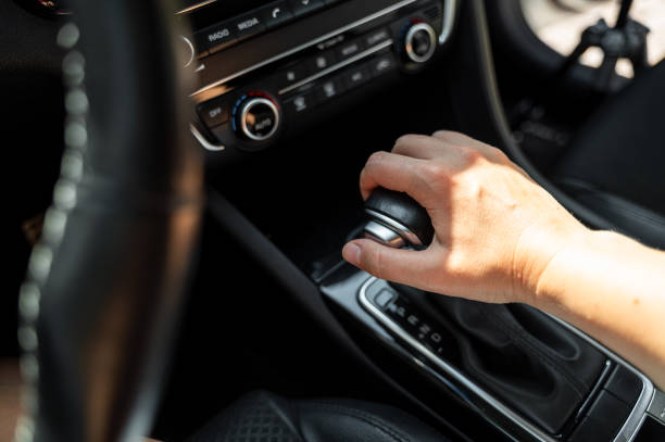 istock Driver hand rests on gear shift of automatic transmission in car 2171468460