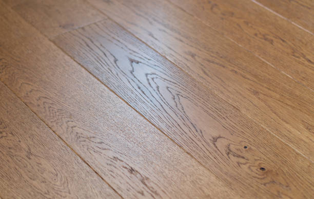 istock Laminated wood floor. Empty room with floating laminate in new apartment. Dark walnut chevron surface. Premium oiled oak parquet texture. 2171468494