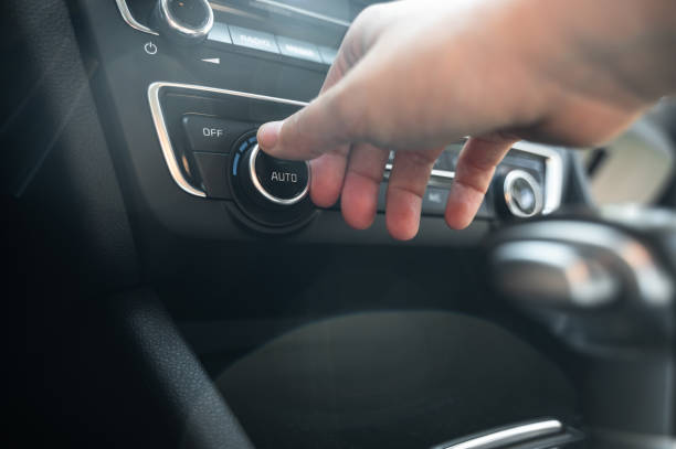 istock Close-up of hand using temperature control knob on car dashboard 2171468529