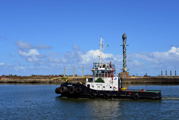 Recife, Pernambuco, Brazil: harbor tug Lacerta (MMSSI 710013210) leaving the harbor, moving north along the breakwater