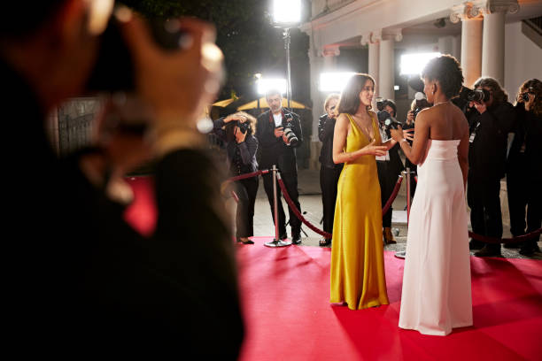 istock Young celebrity and media host conversing on red carpet 2171470827