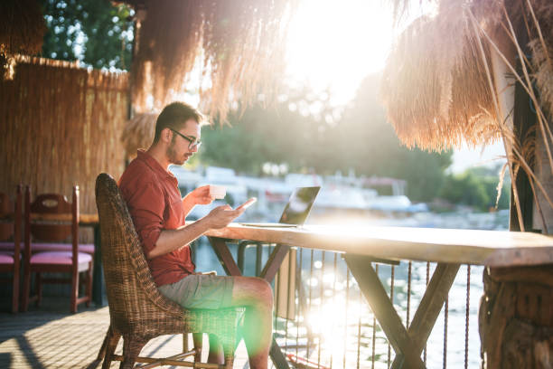 istock Man using mobile phone and laptop in the morning with coffee. 2171470912