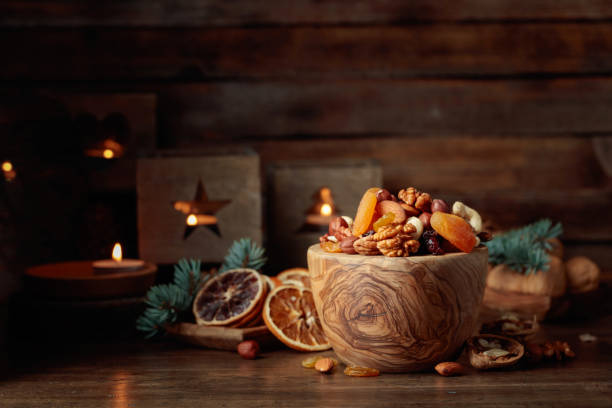 Dried fruits and assorted nuts on an old wooden table.