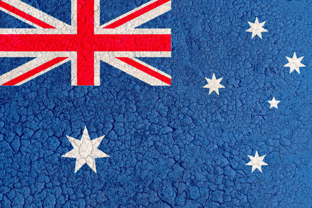 Small paper flag of Australia pinned. Isolated on white background. Horizontal orientation. Close up photography. Copy space.