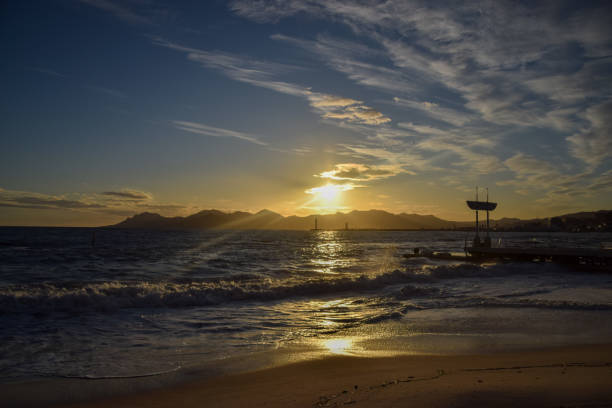 Scenic view of the sea and sandy beach at sunset in Cannes, South of France