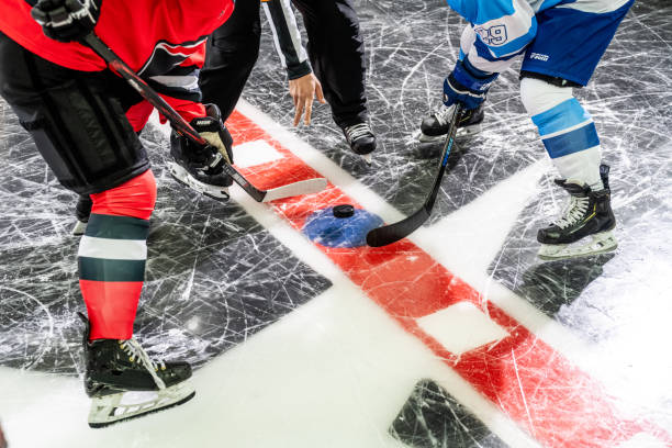 istock Face-Off with Puck Drop on Ice Rink 2171478686
