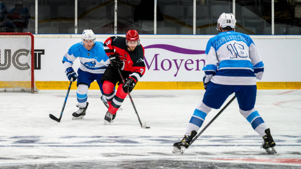 istock Ice Hockey Duel: Offensive Breakthrough, player dribbling against opposing defenders 2171478820