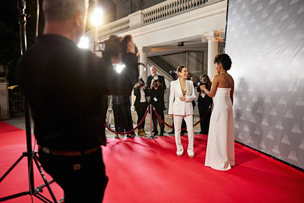 A group of people in casual attire are engaged in conversation within a sleek, blue-lit interior, reflecting a friendly and professional ambiance.
