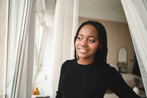 istock Young black woman looking throw window. 2171480170