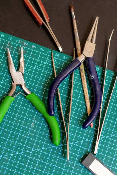 istock Overhead view on tools on a green cutting mat for crafting handmade jewelry things. 2171486477