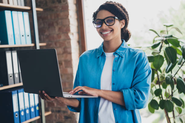 istock Photo of lovely young lady hold netbook working dressed blue shirt comfortable programmer startup office loft room interior 2171487732