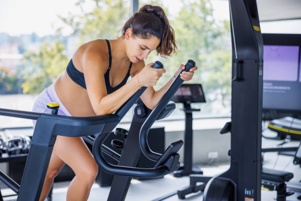 istock Beautiful pregnant woman using exercise machine in the gym 2171487850
