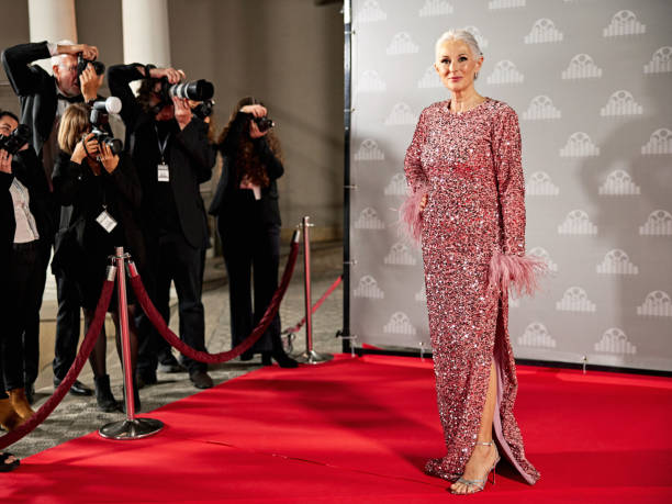 istock Elegant celebrity posing in front of step and repeat wall 2171488254