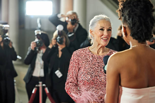 istock Woman with microphone interviewing celebrity at event 2171489302