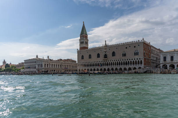 Venezia , summer 2024 , panorama from a Gondola during a boat trip. View of the traditional bridges and palaces  in Venezia
