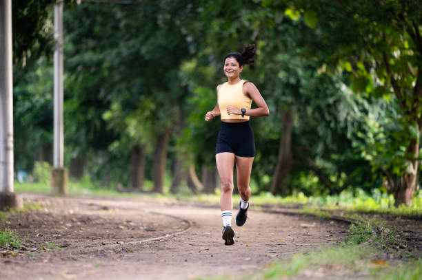 istock Young Woman Running in a Scenic Park 2171495392