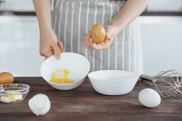 istock Woman Separating Egg Yolk and White for Dough 2171496533