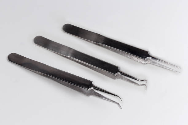 istock Tweezers with straight and curved pointed tips on gray background 2171497903