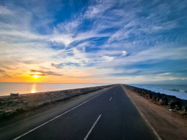 istock Coastal road at sunset with vibrant sky and ocean. 2171498123