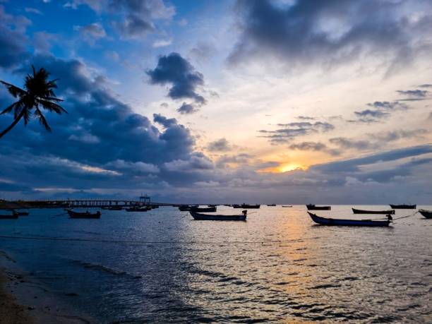 istock Beach sunset with boats and palm tree 2171498126