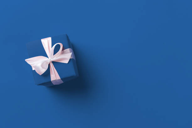 istock Gift box on classic blue background top view 2171500460