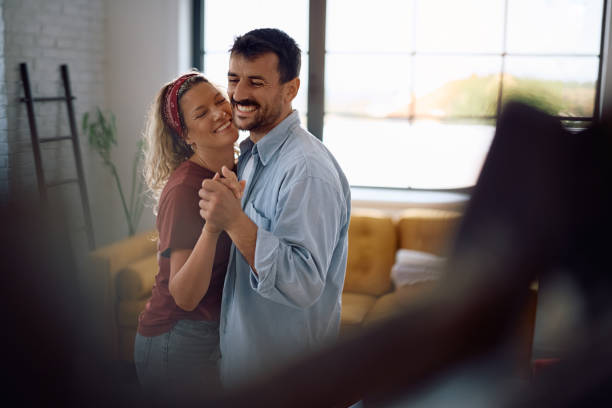 istock Happy couple dancing after relocating into new home. 2171500790