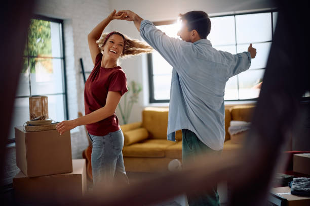istock Playful couple dancing while having fun in the new apartment. 2171500801