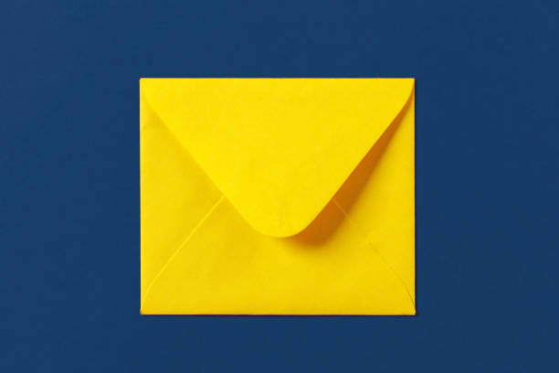 istock Paper yellow envelope on a blue colored background 2171500898
