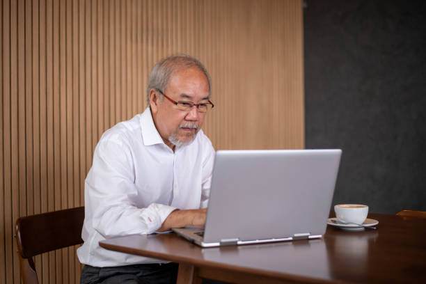 istock Businessman working in a modern office working business on laptop computer and document  collaborating on a project a coffee cup on the table. 2171500916