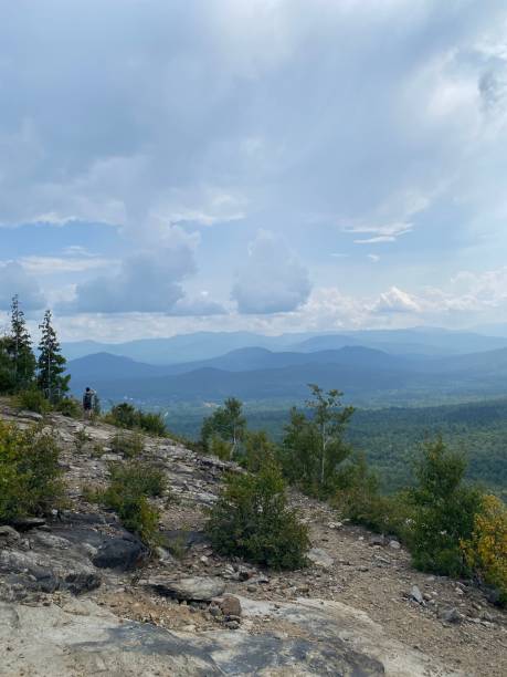 istock Scenic mountain view with hiker and cloudy sky 2171503666